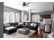 Cozy living room features a large leather sectional, patterned curtains and decorative pillows at 9988 Devonshire St, Douglasville, GA 30135
