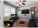 Comfortable living room with a dark sofa, ceiling fan, and framed decorations at 9988 Devonshire St, Douglasville, GA 30135