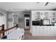 Upstairs landing featuring a table, seating, and a custom cabinet at 9988 Devonshire St, Douglasville, GA 30135