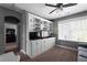 Open living room with custom built-in shelves and cabinets, next to a comfortable sofa at 9988 Devonshire St, Douglasville, GA 30135