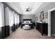 Elegant main bedroom with tray ceiling, dark furniture, and soft carpeting, creating a luxurious retreat at 9988 Devonshire St, Douglasville, GA 30135