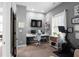 Well-lit home office with large window, modern desk, and Peloton exercise bike at 9988 Devonshire St, Douglasville, GA 30135