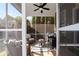 Cozy screened-in porch featuring a ceiling fan and comfortable wicker furniture at 9988 Devonshire St, Douglasville, GA 30135