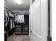 Spacious walk-in closet with custom shelving and ample storage space at 9988 Devonshire St, Douglasville, GA 30135