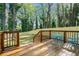 Relaxing backyard featuring a spacious wooden deck, fenced yard, and mature trees at 1555 Olympian Sw Way, Atlanta, GA 30310