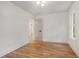 A bright bedroom with wood floors, white trim, and a modern lighting fixture at 1555 Olympian Sw Way, Atlanta, GA 30310