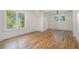 Bright bedroom featuring hardwood floors, a ceiling fan, and natural light from large windows at 1555 Olympian Sw Way, Atlanta, GA 30310