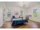 Bedroom featuring hardwood floors, natural light, and a modern light fixture at 1555 Olympian Sw Way, Atlanta, GA 30310