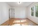 Bright bedroom with hardwood floors, white trim and a sunny window at 1555 Olympian Sw Way, Atlanta, GA 30310