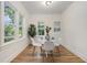 Bright dining room featuring hardwood floors, ample natural light, and stylish contemporary furniture at 1555 Olympian Sw Way, Atlanta, GA 30310