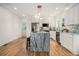 Modern kitchen featuring white cabinets, stainless steel appliances and an island with stone countertop at 1555 Olympian Sw Way, Atlanta, GA 30310