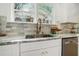 Modern kitchen featuring granite countertops, stainless steel appliances, and a stylish gold faucet at 1555 Olympian Sw Way, Atlanta, GA 30310