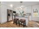 Bright kitchen with white cabinetry, granite countertops, stainless steel appliances, and barstool seating at 1555 Olympian Sw Way, Atlanta, GA 30310