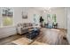 Comfortable living room featuring a neutral sofa, large windows, and hardwood flooring at 1555 Olympian Sw Way, Atlanta, GA 30310