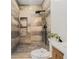Sleek shower featuring elegant tile work, a rainfall shower head, and built in storage at 1555 Olympian Sw Way, Atlanta, GA 30310