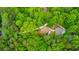 Aerial view reveals a secluded home nestled among dense trees, with a scenic path leading to the residence at 2633 Jonesboro Rd, Fairburn, GA 30213