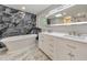 Luxurious bathroom with marble tile, a soaking tub, and dual sink vanity at 2633 Jonesboro Rd, Fairburn, GA 30213