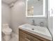 Bathroom featuring a modern vanity, lighted mirror, and toilet at 2633 Jonesboro Rd, Fairburn, GA 30213