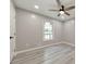 Bedroom featuring wood-look floors, a window, and a ceiling fan at 2633 Jonesboro Rd, Fairburn, GA 30213