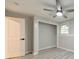 Bedroom featuring gray walls, ceiling fan, light-wood-style floor and closet alcove at 2633 Jonesboro Rd, Fairburn, GA 30213