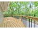 Newly built wooden deck with black metal railing overlooks wooded backyard at 2633 Jonesboro Rd, Fairburn, GA 30213