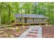 Charming single story home with a welcoming front porch and a beautifully landscaped front yard with stone pathway at 2633 Jonesboro Rd, Fairburn, GA 30213