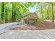 Rear view of the home with a raised deck and parking area at 2633 Jonesboro Rd, Fairburn, GA 30213