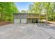 Rear exterior of the home with a raised deck and large parking area at 2633 Jonesboro Rd, Fairburn, GA 30213