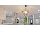 Modern kitchen featuring white cabinets, quartz countertops, stainless steel appliances, and a stylish pendant light at 2633 Jonesboro Rd, Fairburn, GA 30213