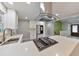Bright kitchen with stainless steel appliances, quartz countertops, and a stylish island with a gas cooktop at 2633 Jonesboro Rd, Fairburn, GA 30213