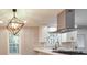 Modern kitchen boasting white cabinets, stainless steel appliances, stylish backsplash, and a contemporary pendant light fixture at 2633 Jonesboro Rd, Fairburn, GA 30213