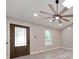 Bright living room features modern ceiling fan, stylish flooring, and abundant natural light creating a welcoming atmosphere at 2633 Jonesboro Rd, Fairburn, GA 30213