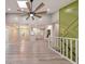 Open floor plan with modern finishes including vaulted ceilings, sleek flooring, and seamless transition to the kitchen area at 2633 Jonesboro Rd, Fairburn, GA 30213