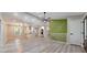 Open-concept living area with seamless flow to the kitchen featuring modern floors, lighting, and accent wall at 2633 Jonesboro Rd, Fairburn, GA 30213