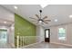 Bright living room boasts vaulted ceilings, modern ceiling fan, accent wall, and stylish flooring for a contemporary feel at 2633 Jonesboro Rd, Fairburn, GA 30213