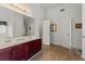 Bathroom with a double sink vanity, large mirror, and tile flooring at 3971 Busby Mill Ct, Ellenwood, GA 30294