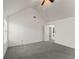 A bedroom with vaulted ceilings, neutral walls, gray carpet, and a window for natural light at 3971 Busby Mill Ct, Ellenwood, GA 30294