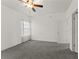 Bright bedroom featuring neutral walls, ceiling fan, window with blinds and carpeted floor at 3971 Busby Mill Ct, Ellenwood, GA 30294