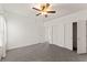 Spacious carpeted bedroom with a ceiling fan, neutral walls, closet and multiple doors at 3971 Busby Mill Ct, Ellenwood, GA 30294