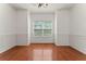 Bright, empty dining room featuring hardwood flooring and wainscoting detail at 3971 Busby Mill Ct, Ellenwood, GA 30294