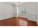 Bright, empty dining room featuring hardwood flooring and wainscoting detail at 3971 Busby Mill Ct, Ellenwood, GA 30294