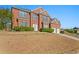 Lovely two-story brick home boasts manicured shrubs and a two-car garage at 3971 Busby Mill Ct, Ellenwood, GA 30294