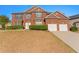 Inviting brick two-story home featuring a two-car garage and well-maintained landscaping at 3971 Busby Mill Ct, Ellenwood, GA 30294