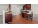 Hardwood floors, stainless appliances and granite countertops adorn this spacious kitchen area at 3971 Busby Mill Ct, Ellenwood, GA 30294