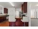 Kitchen boasts stainless appliances, granite countertops, hardwood floors and a breakfast bar at 3971 Busby Mill Ct, Ellenwood, GA 30294