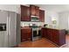 Well-equipped kitchen with stainless steel appliances, granite counters and wood cabinets at 3971 Busby Mill Ct, Ellenwood, GA 30294