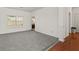 Spacious living room featuring neutral carpet and elegant archways at 3971 Busby Mill Ct, Ellenwood, GA 30294