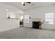 Inviting living room with fireplace, lots of natural light, and an open view to the kitchen at 3971 Busby Mill Ct, Ellenwood, GA 30294