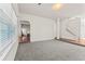 Bright, spacious living room featuring neutral carpet and open staircase at 3971 Busby Mill Ct, Ellenwood, GA 30294