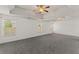 Spacious main bedroom with tray ceilings, fan, natural light, and neutral carpet at 3971 Busby Mill Ct, Ellenwood, GA 30294